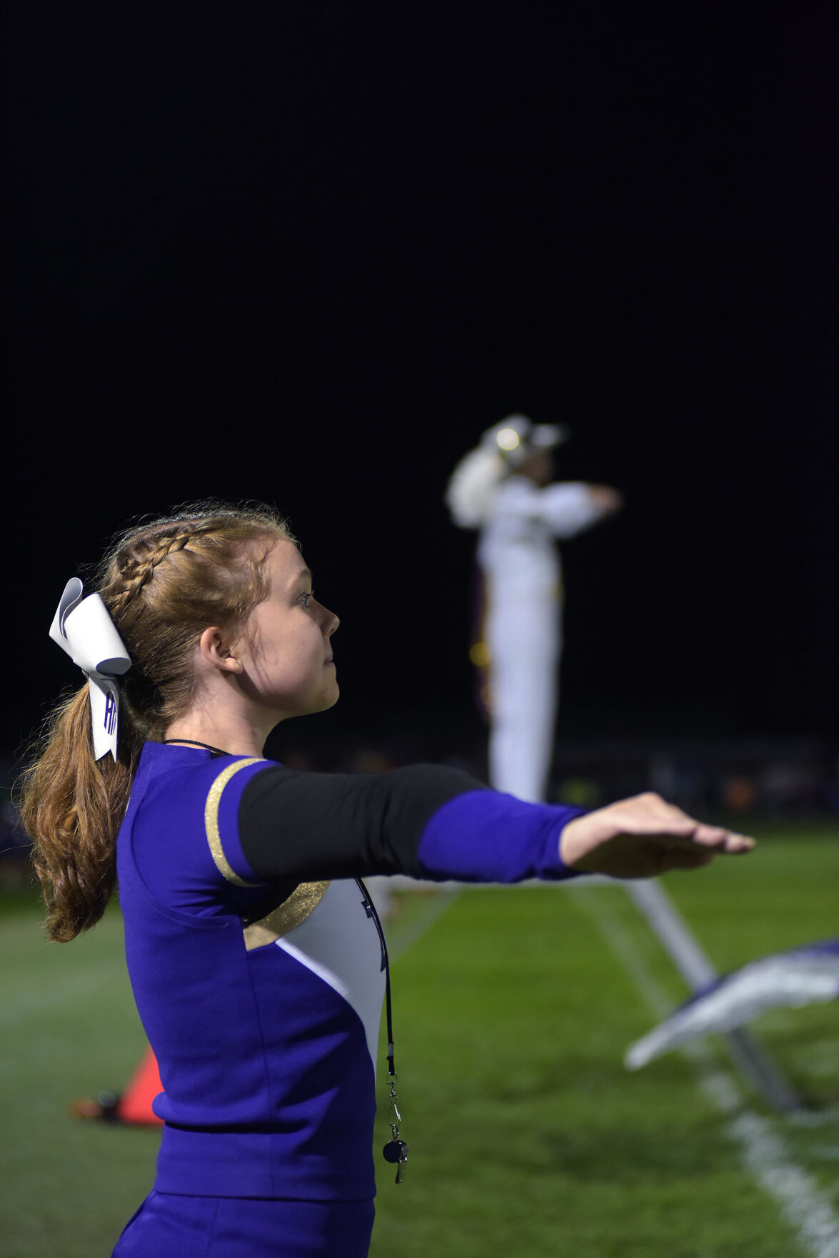 Junior Drum Major Olivia Gill directs the band for the half-time